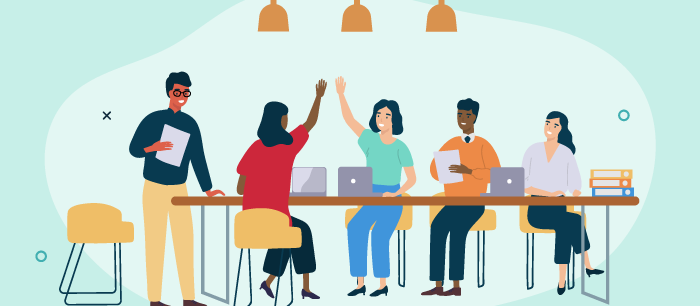 Group of coworkers working. Two are high fiving